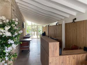 a waiting room with a row of tables and flowers at Alacati Moonbox Hotel in Alacati