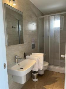 a bathroom with a sink and a toilet at Alacati Moonbox Hotel in Alacati