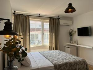 a bedroom with a bed and a window at Alacati Moonbox Hotel in Alacati