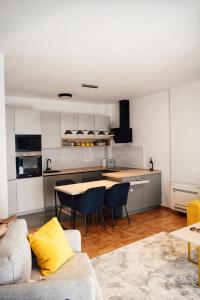 a kitchen and living room with a table and chairs at The Impressive Apartment in Trebinje