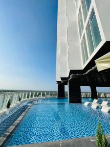 a swimming pool on the side of a building at Diamond Stars Ben Tre Hotel in Ben Tre