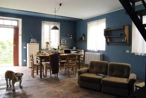 a dog standing in a living room with a table at Fattoria Barbialla Nuova in Montaione