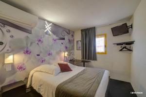 a hotel room with a bed and flowers on the wall at Hôtel The Originals Access, Bourges Nord Saint-Doulchard in Bourges