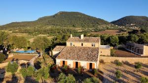 an aerial view of a house with a mountain in the background at Fincahotel Treurer - Olive Grove & Grand House - Adults Only in Algaida