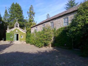 an old stone building with a cross on top of it at Quinta da Comenda in São Pedro do Sul