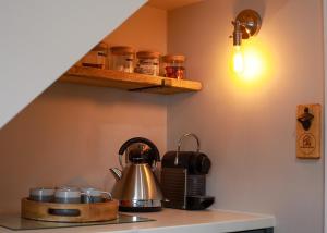 a kitchen with a tea kettle on a stove at Auctioneers Cottage in Louth +36 photos