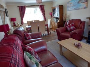 a living room with a couch and a table at Pet Friendly Beautiful Detached Cottage close to Spurn Point, Easington and Withersea in Hull