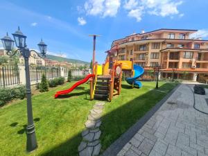 a playground in a park with a slide at Sea Dreams Apartment in Sveti Vlas