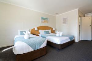 a hotel room with two beds with towels on them at Hospitality Esperance SureStay Collection by Best Western in Esperance