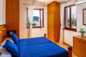 a bedroom with a blue bed and a window at LUXE SPLIT Beach COLLECTION in Split