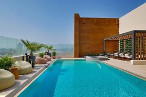 a swimming pool on the roof of a building at Courtyard by Marriott Culture Village, Dubai in Dubai