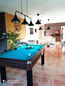 a pool table in the middle of a living room at Las Palmeras in Alberique