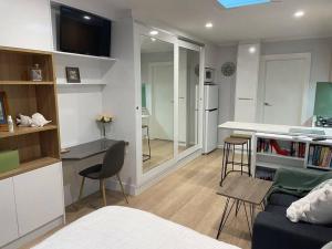 a living room with a couch and a table and a kitchen at oasis by the beach in Glenelg