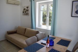 a living room with a couch and a table at Lovely View in Kampos Paros