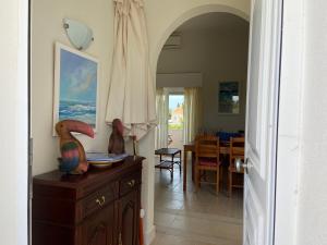a hallway with a dining room with a table at Apartamento na Vila Senhora da Rocha in Porches