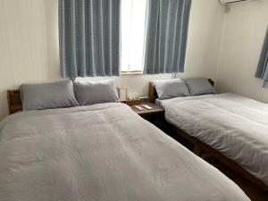 Rúm í herbergi á The Ritz Okinawa Kise 2-Free parking for 2 cars, 3LDK, 2 bathrooms