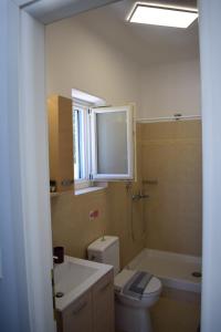 a bathroom with a toilet and a sink and a tub at Lovely View in Kampos Paros +64 photos