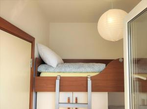 a bunk bed in a room with a mirror at Apartment Rose in Krk