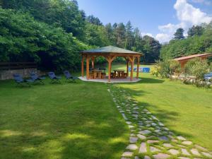 a gazebo with chairs and a table in a yard at Country House Foglie d'erba in Calavino +41 photos