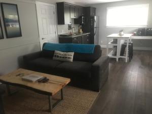 a living room with a couch and a table at Hot Tub Hideaway in Shawnigan Lake