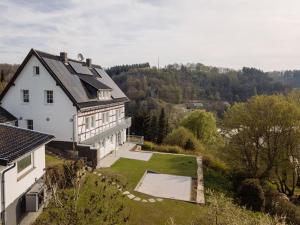 una gran casa blanca con una piscina en el patio en Bienenhaus, en Monschau
