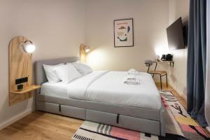 a bedroom with a large bed in a room at Flok Tkalciceva - Main Street Rooms & Apartments in Zagreb