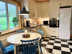 a kitchen with a table with a candle on it at Nice holiday home with a view of lake Asnen in Hulevik, Lonashult in Lönashult