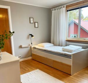 a small bedroom with a bed and a window at Nice holiday home with a view of lake Asnen in Hulevik, Lonashult in Lönashult
