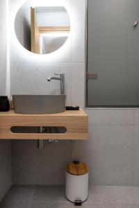 a bathroom with a sink and a mirror at Terrace Sky View in Naxos Chora