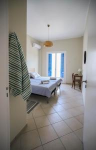 a bedroom with a bed and a table in a room at Rhodes Town Garden Apartment in Rhodes Town