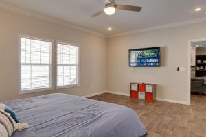 a bedroom with a bed and a flat screen tv at Pisgah Private Retreat Family Getaway with Hot Tub in Balsam Grove