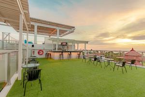 a patio with chairs and tables on a roof at Holiday Inn Express Baruna, an IHG Hotel in Kuta