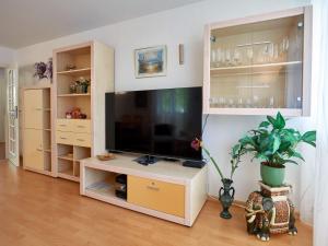 a living room with a large entertainment center with a flat screen tv at Strandwohnungen Sellin - WG06 mit 2 Balkonen in Ostseebad Sellin