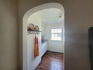 a hallway with an archway in a home with a kitchen at Moon Lakeview Apt at Crescent Lk in St Petersburg