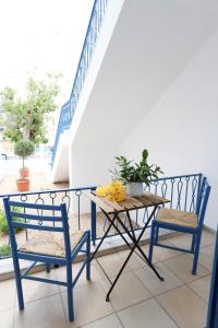 a table and two chairs on a balcony at Traditional Town Garden Apartment in Rhodes Town +58 photos