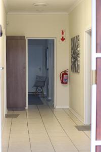 a hallway with a chair in a room at 27 on Gunn Street in Bloemfontein