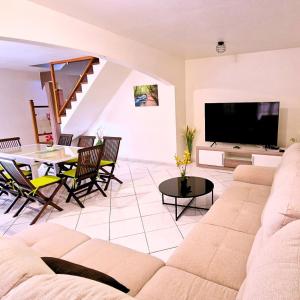 a living room with a couch and a table at Atlantic Gites in Capesterre-Belle-Eau