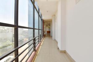 an empty corridor in a building with windows at FabHotel Fly View in Jaipur
