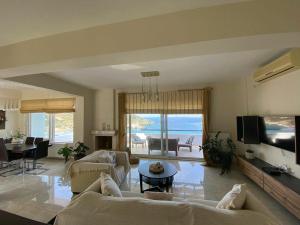 a living room with a couch and a tv at Villa Kapsali in Kythira