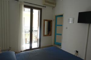 a bedroom with a bed and a large window at La Luna in Castellammare del Golfo +4 photos
