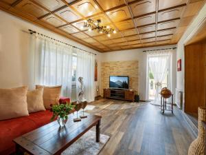 a living room with a couch and a tv at Ferienwohnung Luna in Wörgl