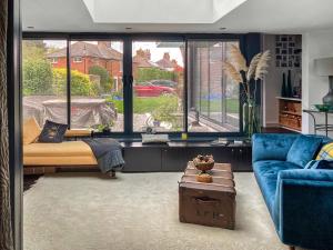 a living room with a bed and a blue couch at The Studio in Wingham