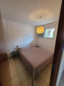 a bedroom with a bed and a window at Appartement T2 Bord de Mer - Maria Beach in Santa-Lucia-di-Moriani