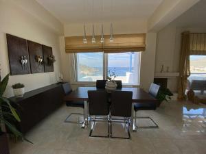 a living room with a dining room table and chairs at Villa Kapsali in Kythira