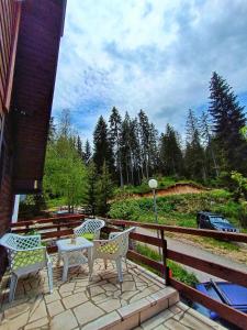 a patio with a table and chairs on a deck at Apartments Sipcic in Žabljak