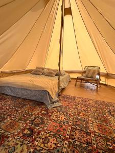 a bedroom with a bed and a rug in a tent at Aparra Surfcamp Saint-Jean-de-Luz in Saint-Jean-de-Luz