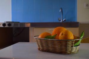 a basket of oranges sitting on top of a counter at Victoria in Plakias