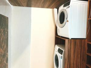 a microwave and a toaster oven on a shelf at Sylvia Hotel & Resort Komodo in Labuan Bajo