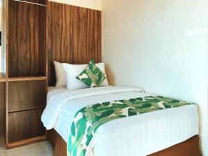 a bedroom with a large bed with a wooden headboard at Sylvia Hotel & Resort Komodo in Labuan Bajo