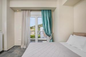 a bedroom with a large bed and a window at Aegean Sea View Villa in Pefkochori